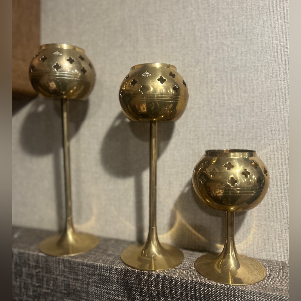 Set of three brass tea light candlesticks